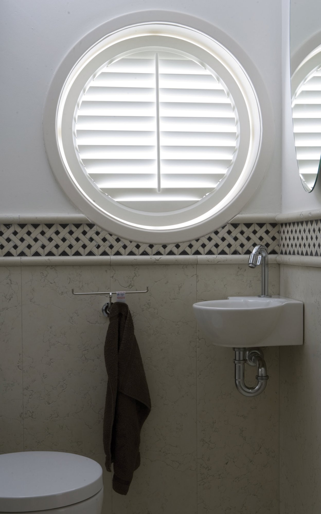 Specialty shapes custom shutter for circular bathroom window – Las Vegas